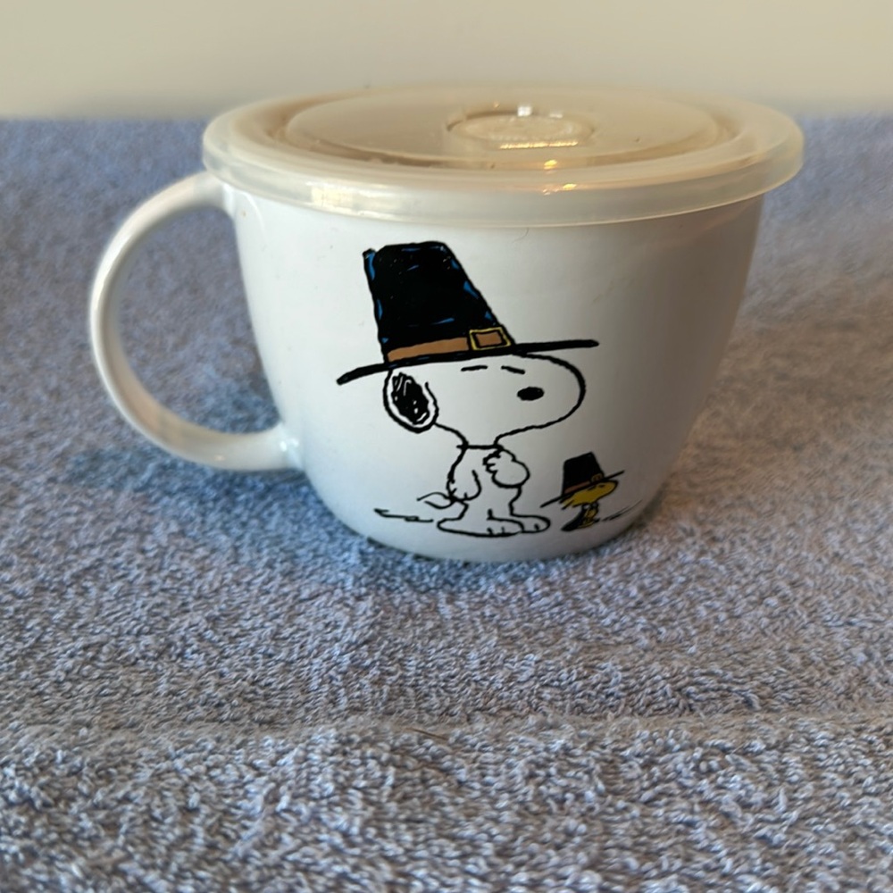 Peanuts soup container, or oversized coffee cup.
